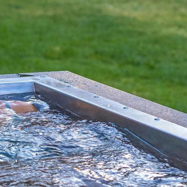 Woman relaxing in a premium cold plunge tub outdoors, showcasing high-end ice bath setup for wellness businesses
