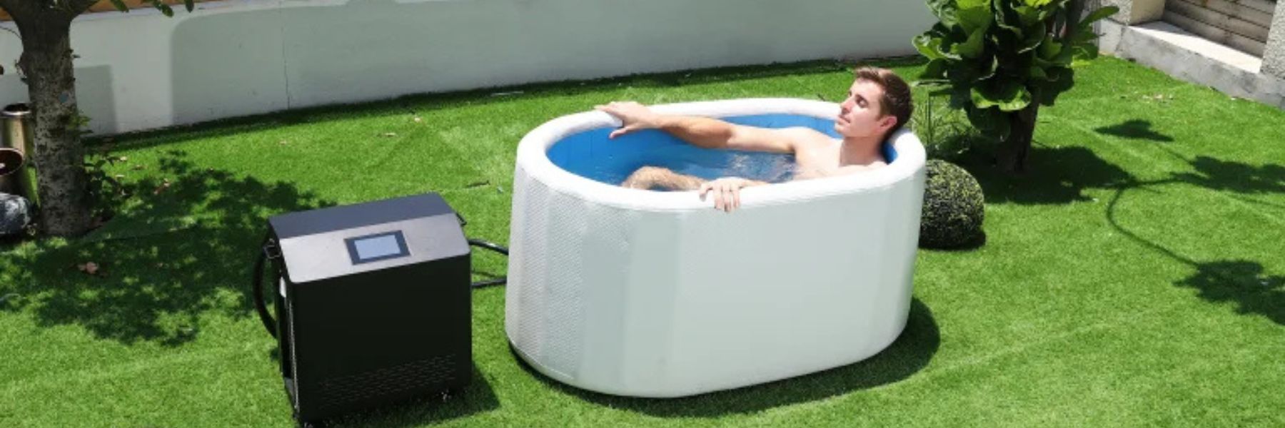 Man relaxing in a cold plunge tub connected to a water chiller, showing consistent cold therapy without ice