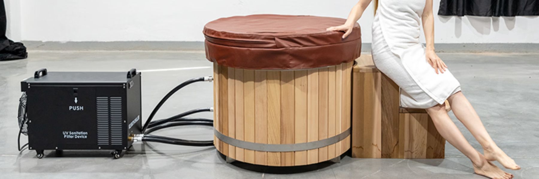Wooden barrel cold plunge tub with water chiller system, showcasing modern cold therapy setup for home use