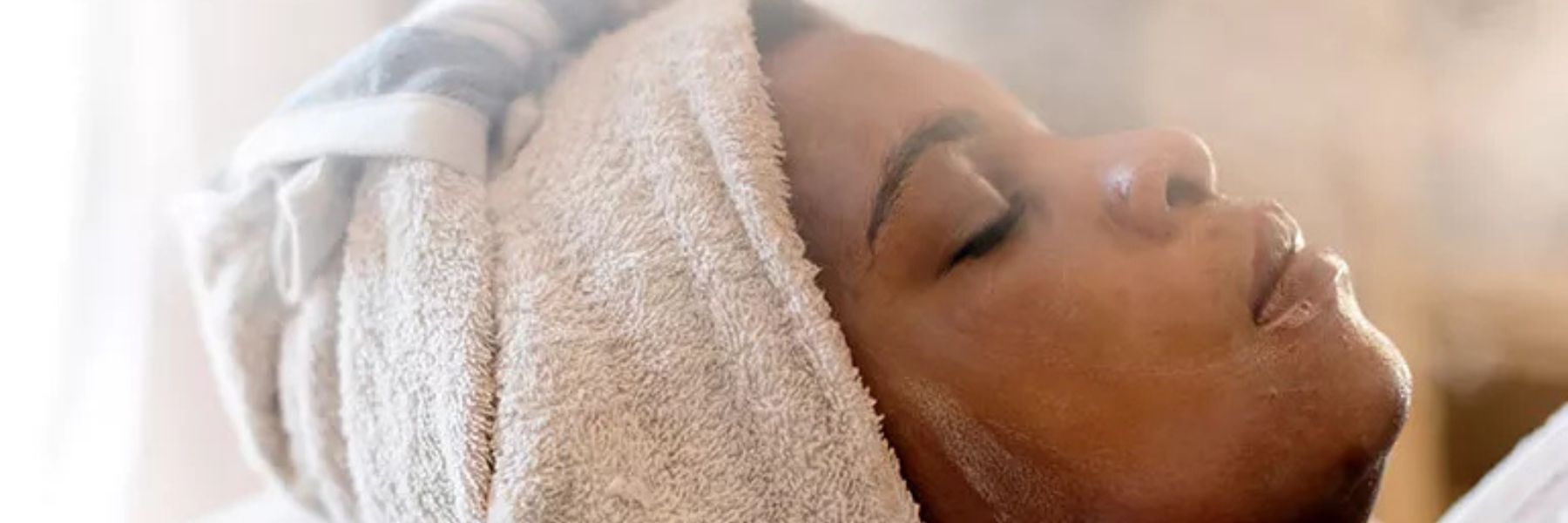 Close-up of woman’s face after steam room session, showing skin hydration and potential effects on pores