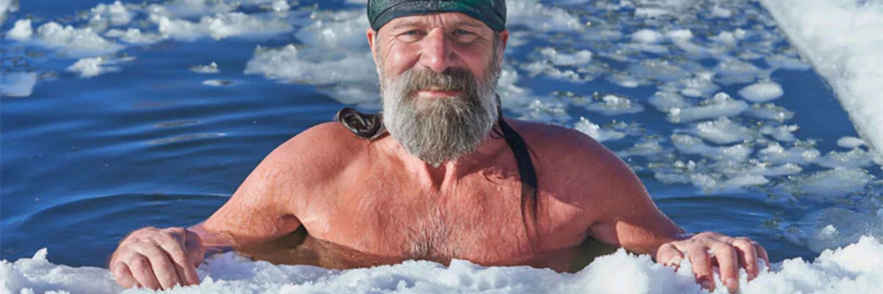 Athlete sitting in an outdoor ice bath during cold plunge therapy for recovery and wellness