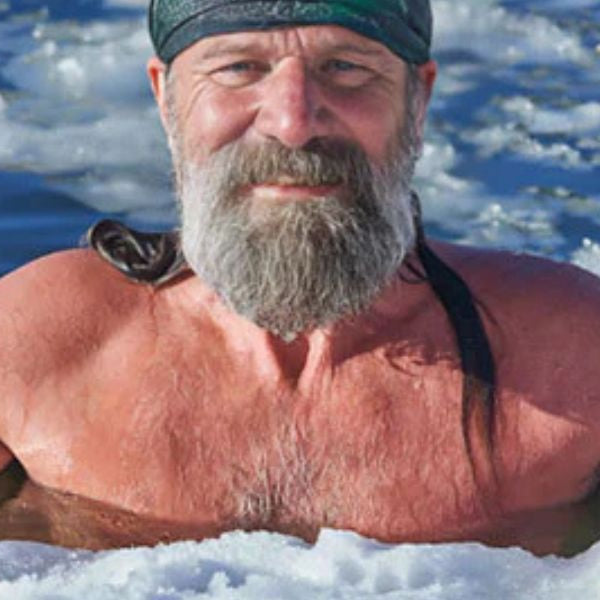 Athlete sitting in an outdoor ice bath during cold plunge therapy for recovery and wellness