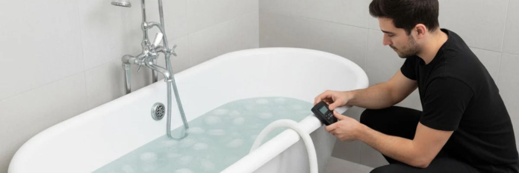 Modern cold plunge tub connected to a water chiller preparing an ice bath for recovery therapy.