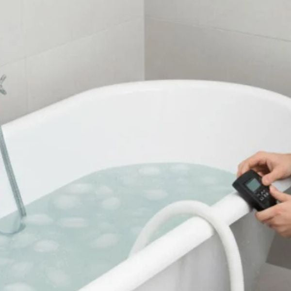 Modern cold plunge tub connected to a water chiller preparing an ice bath for recovery therapy.