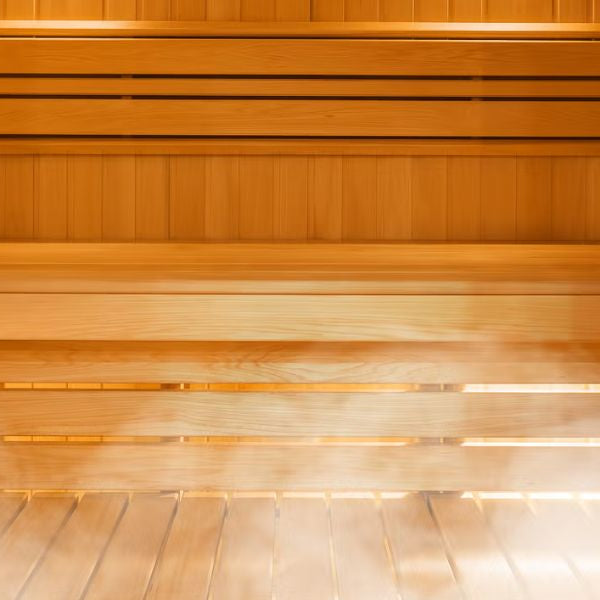 Traditional sauna interior with wooden benches and heater representing cost of sauna installation