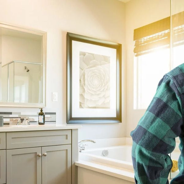 Contractor inspecting bathroom before installing a steam shower system in modern home