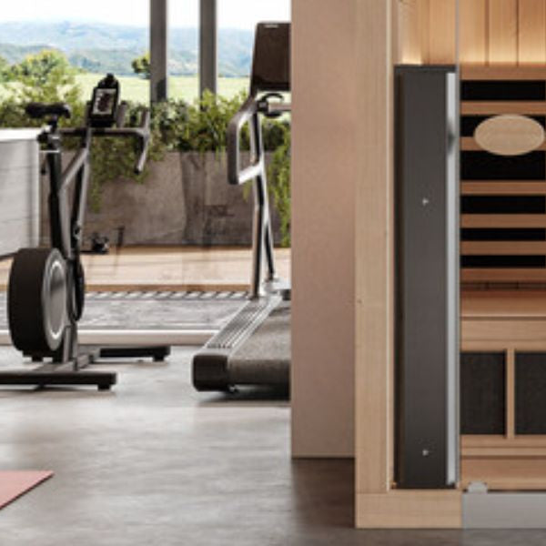 Home gym with infrared sauna, illustrating integration of heat therapy into fitness and recovery routine