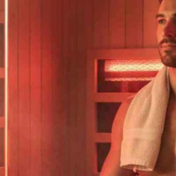 Man relaxing in infrared sauna after workout, supporting muscle recovery and post-exercise relaxation