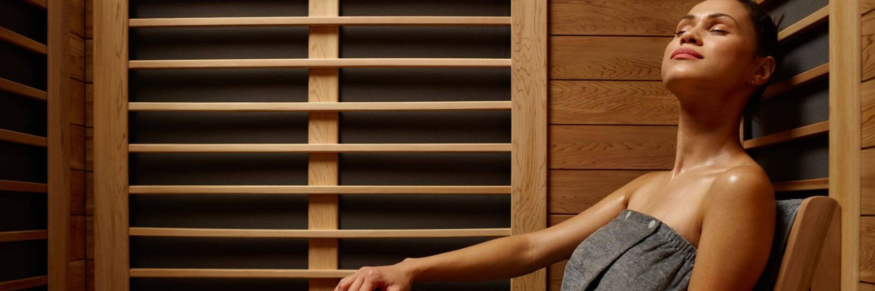 Woman relaxing in infrared sauna, supporting menopause symptom relief and hormonal balance
