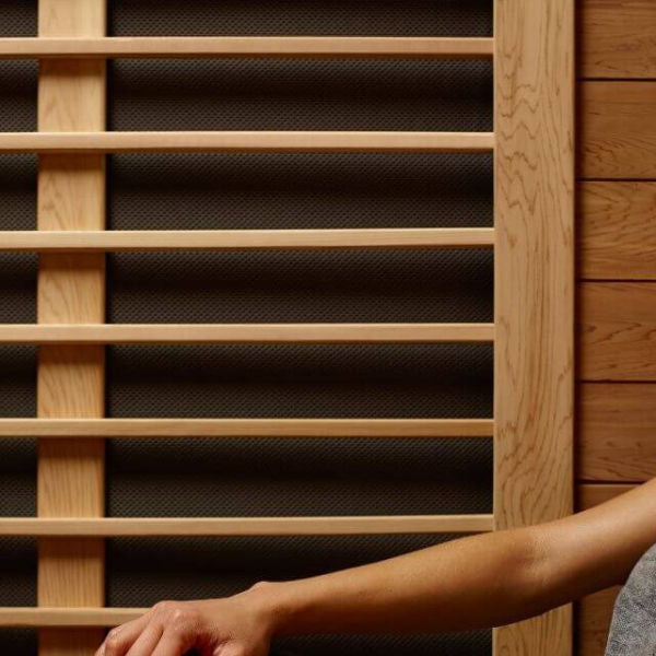 Woman relaxing in infrared sauna, supporting menopause symptom relief and hormonal balance