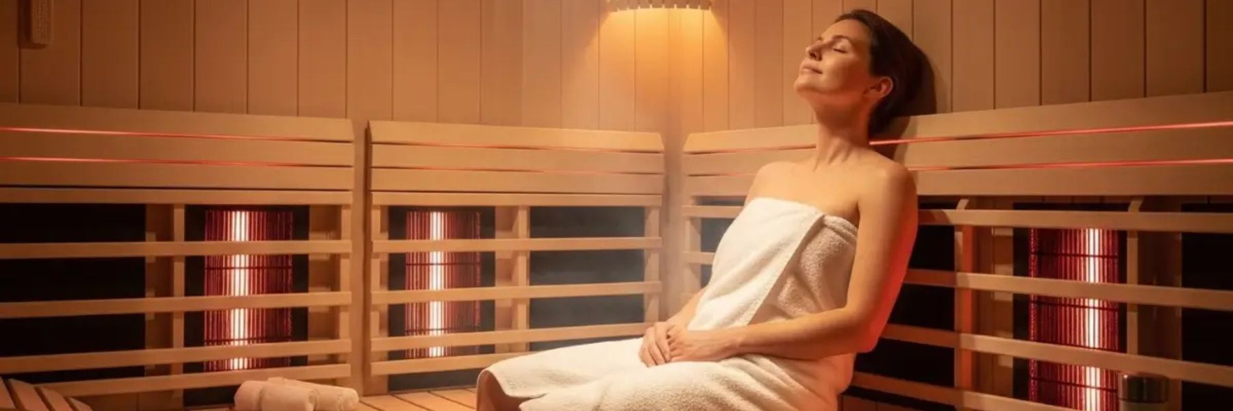 Woman resting in infrared sauna, promoting muscle recovery, reduced soreness, and relaxation