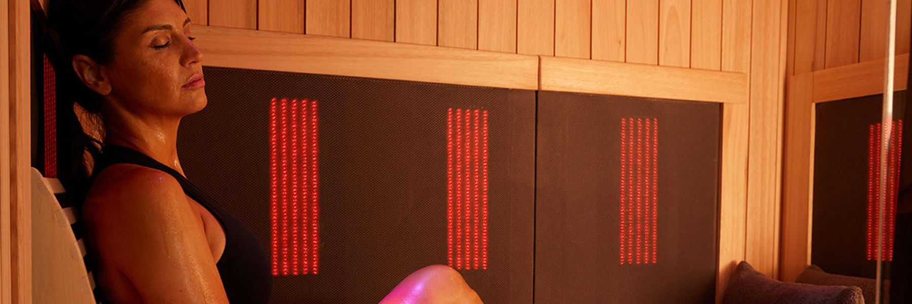 Woman relaxing in infrared sauna, supporting hormonal balance and PCOS symptom relief