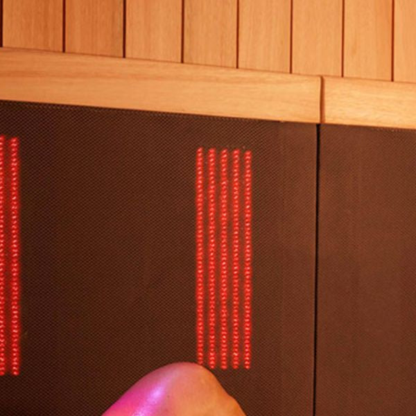 Woman relaxing in infrared sauna, supporting hormonal balance and PCOS symptom relief