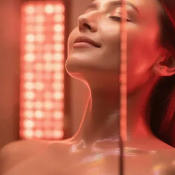Woman enjoying red light therapy in infrared sauna, supporting skin healing and sunburn recovery