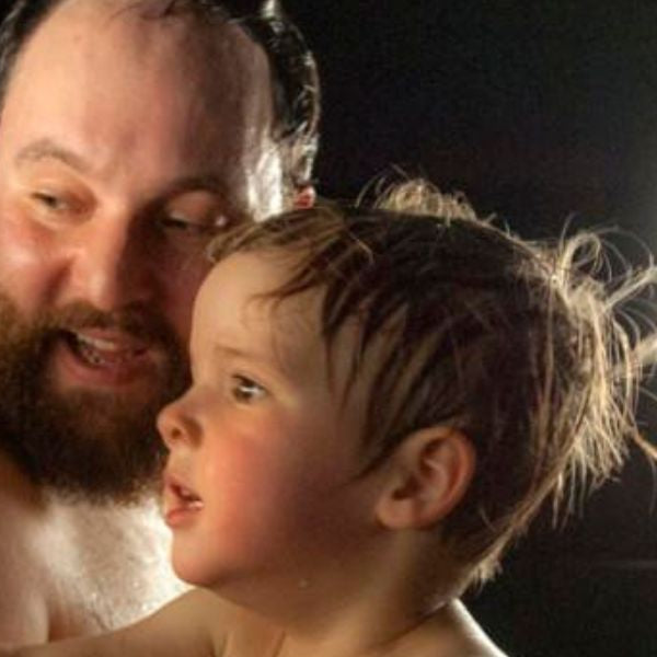 Parent holding toddler in a steam-filled room helping relieve croup symptoms and ease breathing