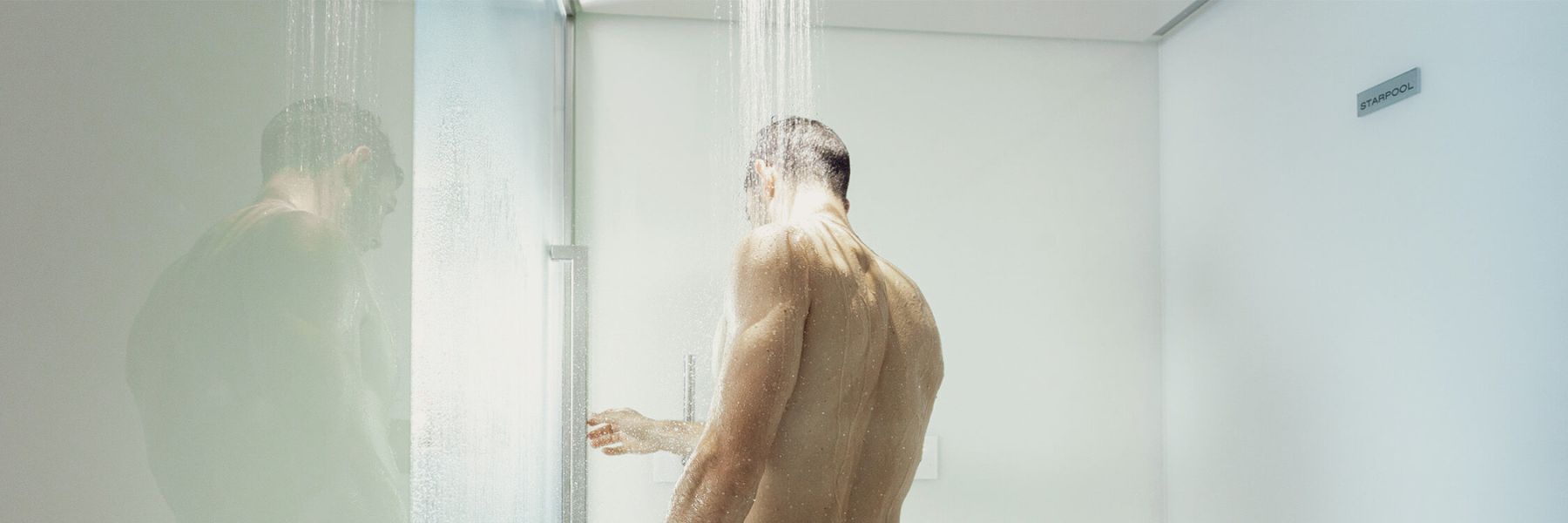 Man using a steam shower with warm mist supporting bronchitis relief and easier breathing