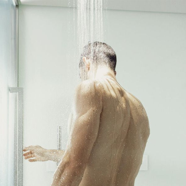 Man using a steam shower with warm mist supporting bronchitis relief and easier breathing