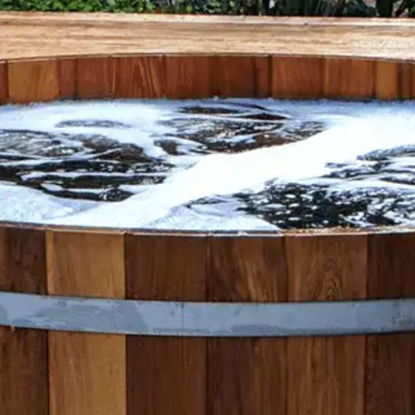 Traditional cedar cold plunge tub at a wellness retreat
