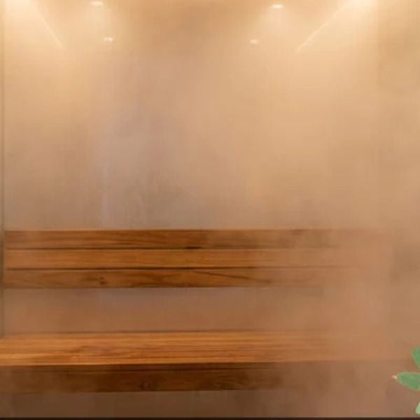 Modern steam shower interior with wooden bench and steam creating a relaxing spa-like environment