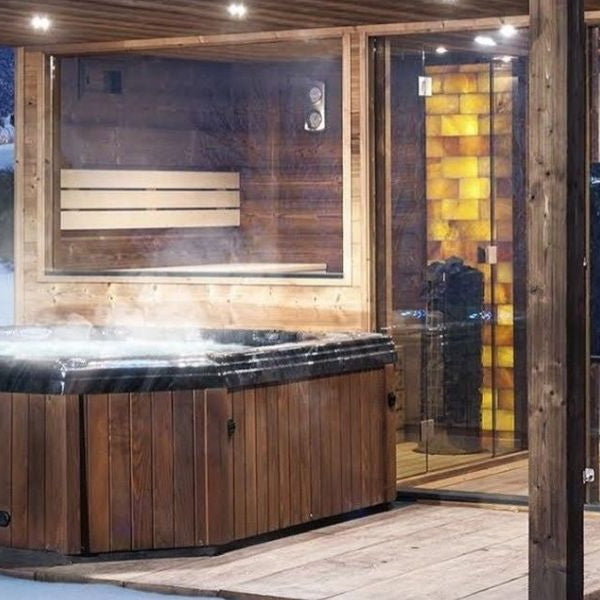 Outdoor sauna, steam room and hot tub combination in winter illustrating spa routine sequence