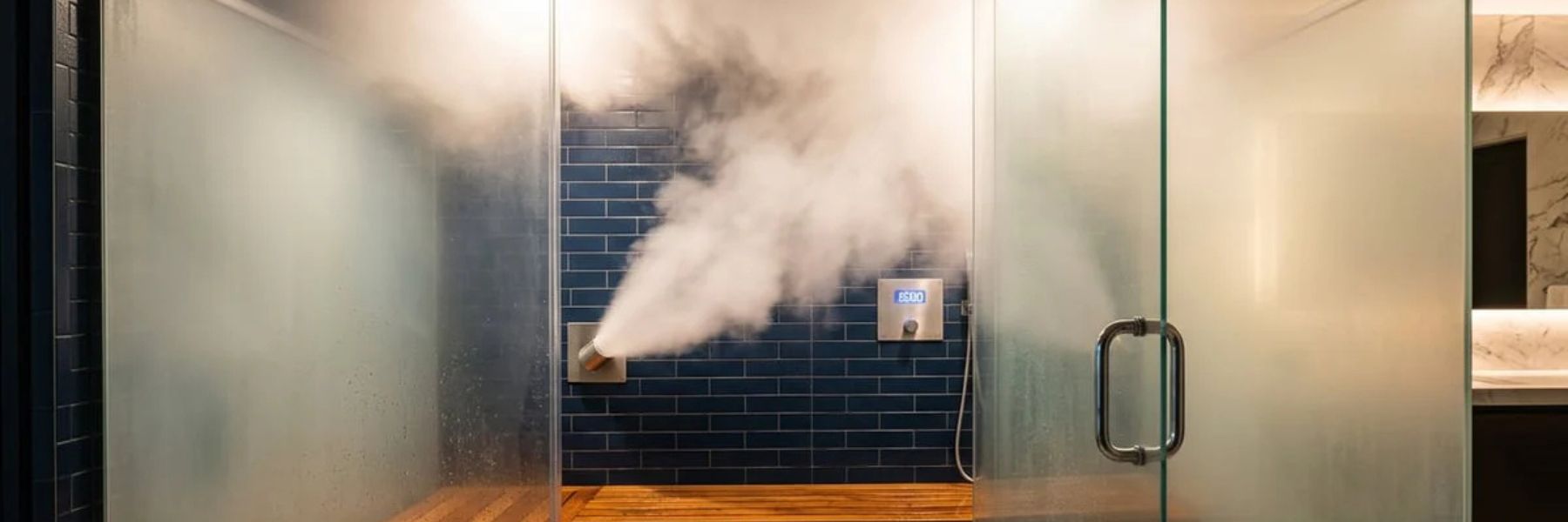 Luxury steam shower with visible steam output and seating in spa-style bathroom