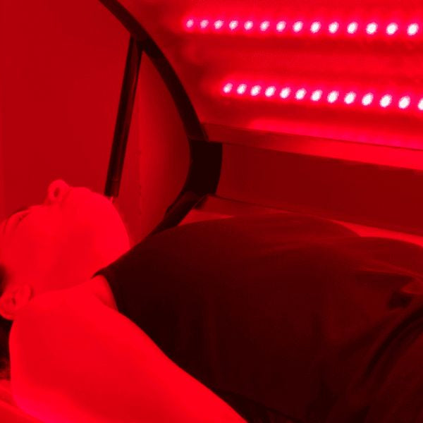 Woman exposed to intense red light therapy, demonstrating possible drawbacks and skin sensitivity risks