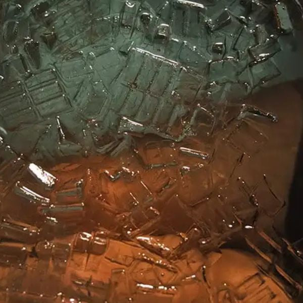 Woman relaxing in a cold plunge tub filled with ice during ice bath therapy for arthritis relief and recovery.