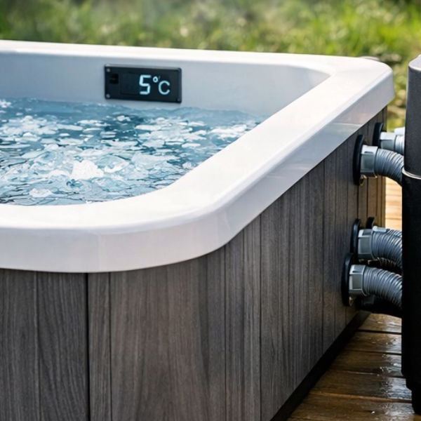 Cold plunge tub with external water chiller unit showing temperature display, illustrating electricity usage and running costs for an ice bath system.