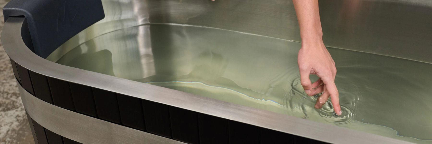 Cleaning the interior of a cold plunge tub during routine maintenance
