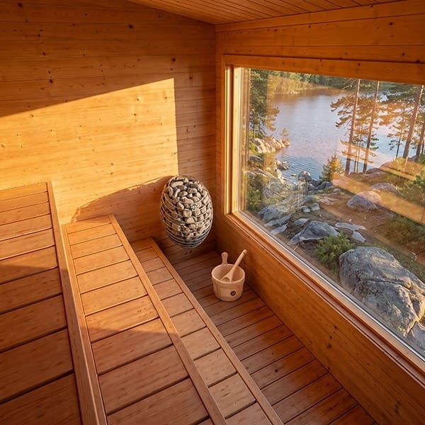 Inside the CT Avalon sauna: three-tier cedar benches and the panoramic window over the lake