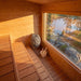 Inside the CT Avalon sauna: three-tier cedar benches and the panoramic window over the lake