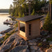 CT Avalon outdoor sauna on a lakeside rock outcrop with a dock beyond