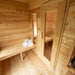 Wooden sauna interior with benches and towels