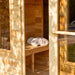 Wooden sauna with towels on a bench, surrounded by natural light
