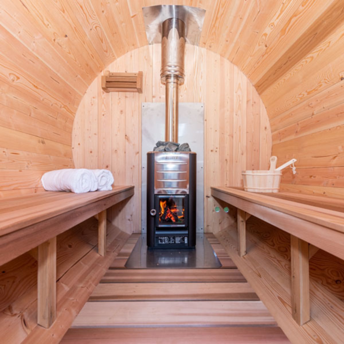 The Dundalk CT Harmony Wood Burning Barrel Sauna with a wood burning heater and a chimney.