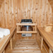 Wooden sauna interior with benches, heater, and towels.