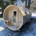 Wooden barrel-shaped sauna in a snowy outdoor setting