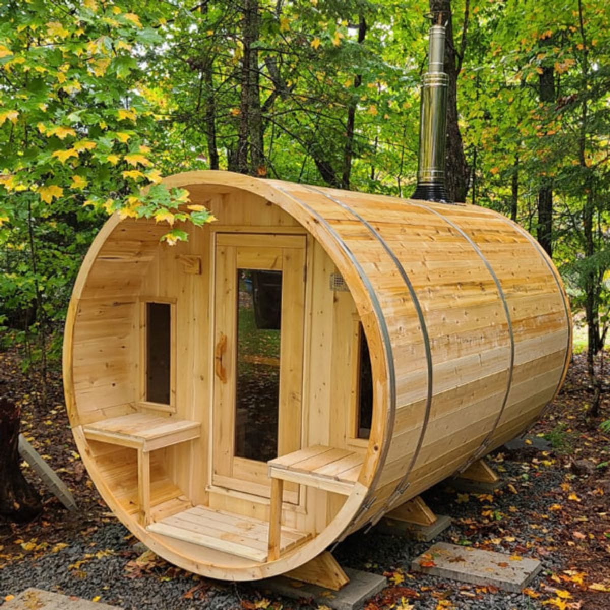 Wooden barrel-shaped sauna in a forest setting