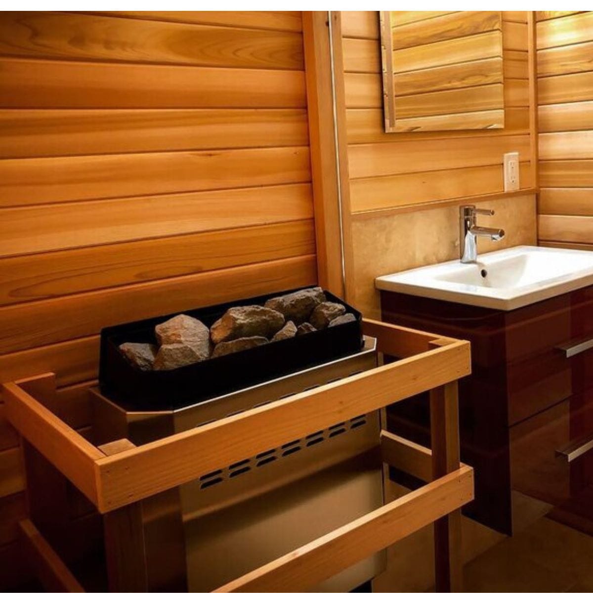 Wooden cover with sauna, rocks, and a sink in a wooden room