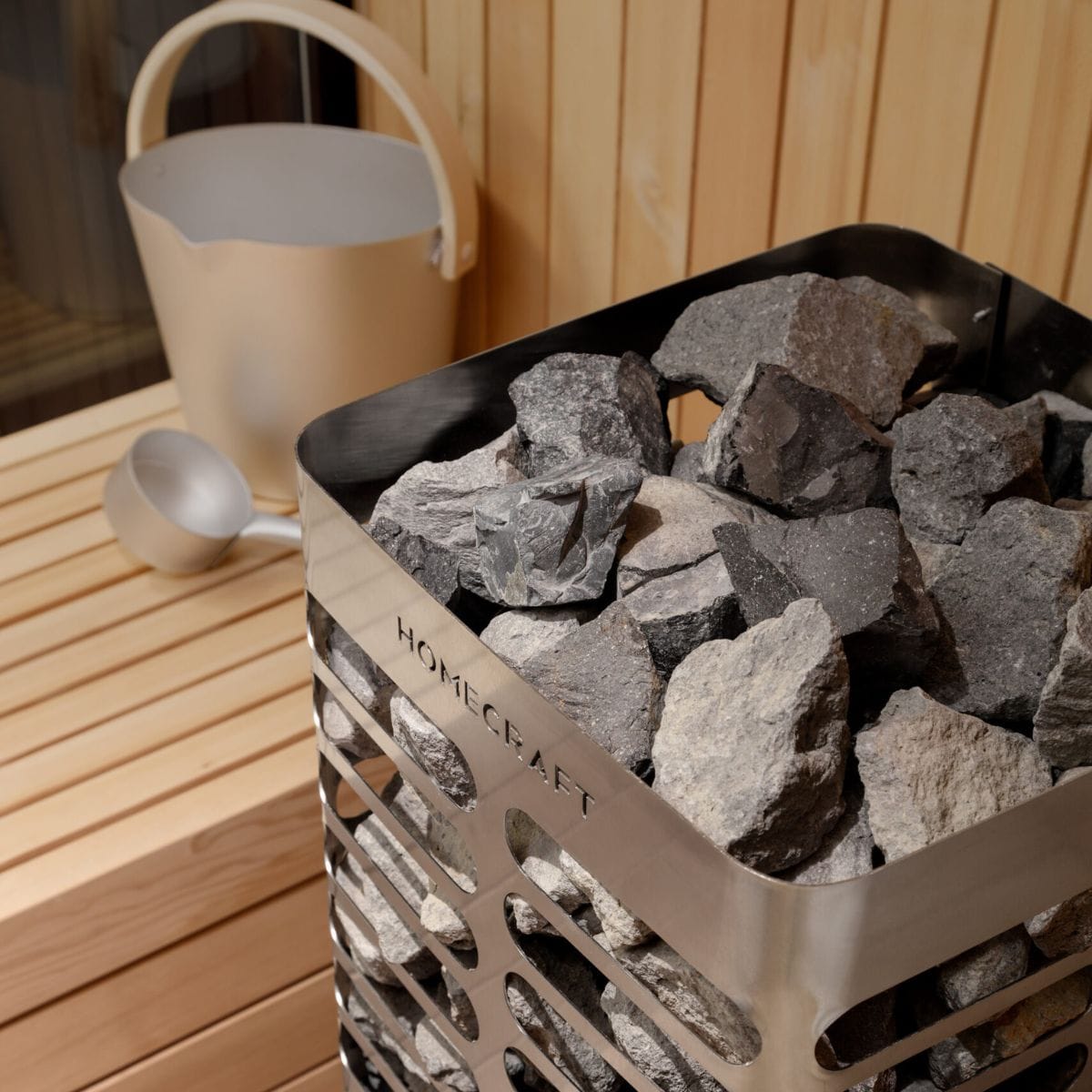 Heater with stones with 'Homecraft' branding on a wooden surface