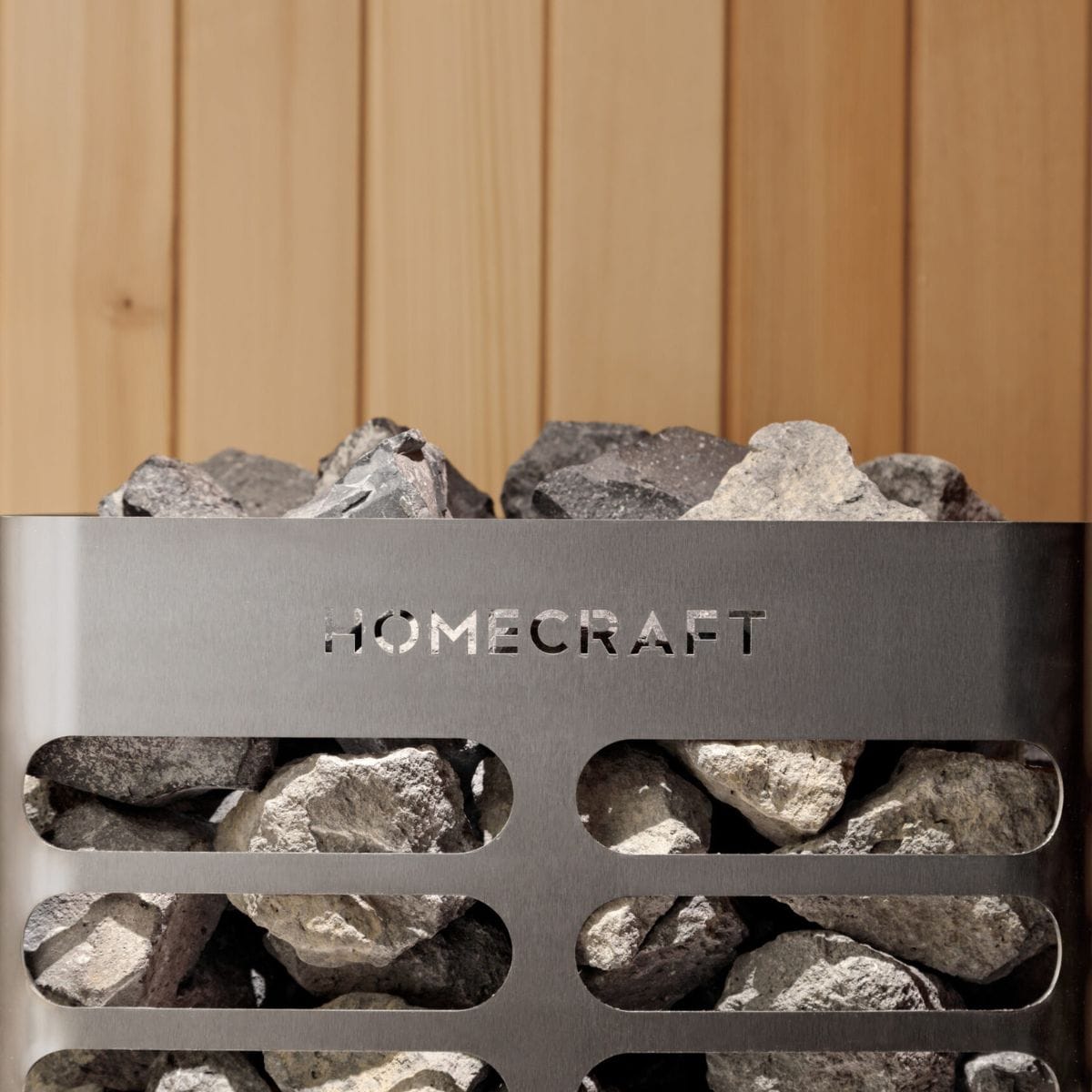 Metallic heater with stones and 'Homecraft' branding against a wooden background