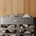 Metallic heater with stones and 'Homecraft' branding against a wooden background