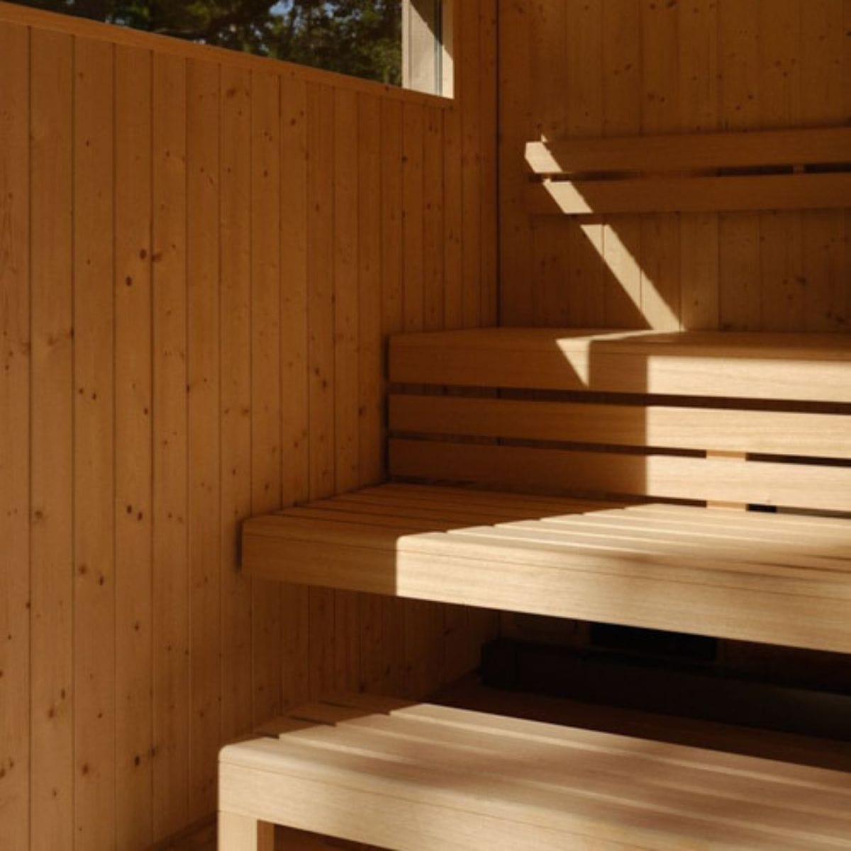 Wooden bench inside a wooden structure, possibly a sauna or cabin.