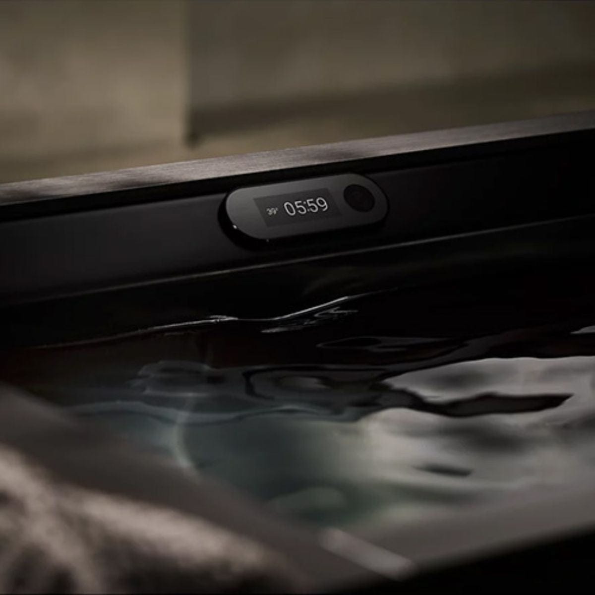 Digital clock display on a dashboard with water droplets