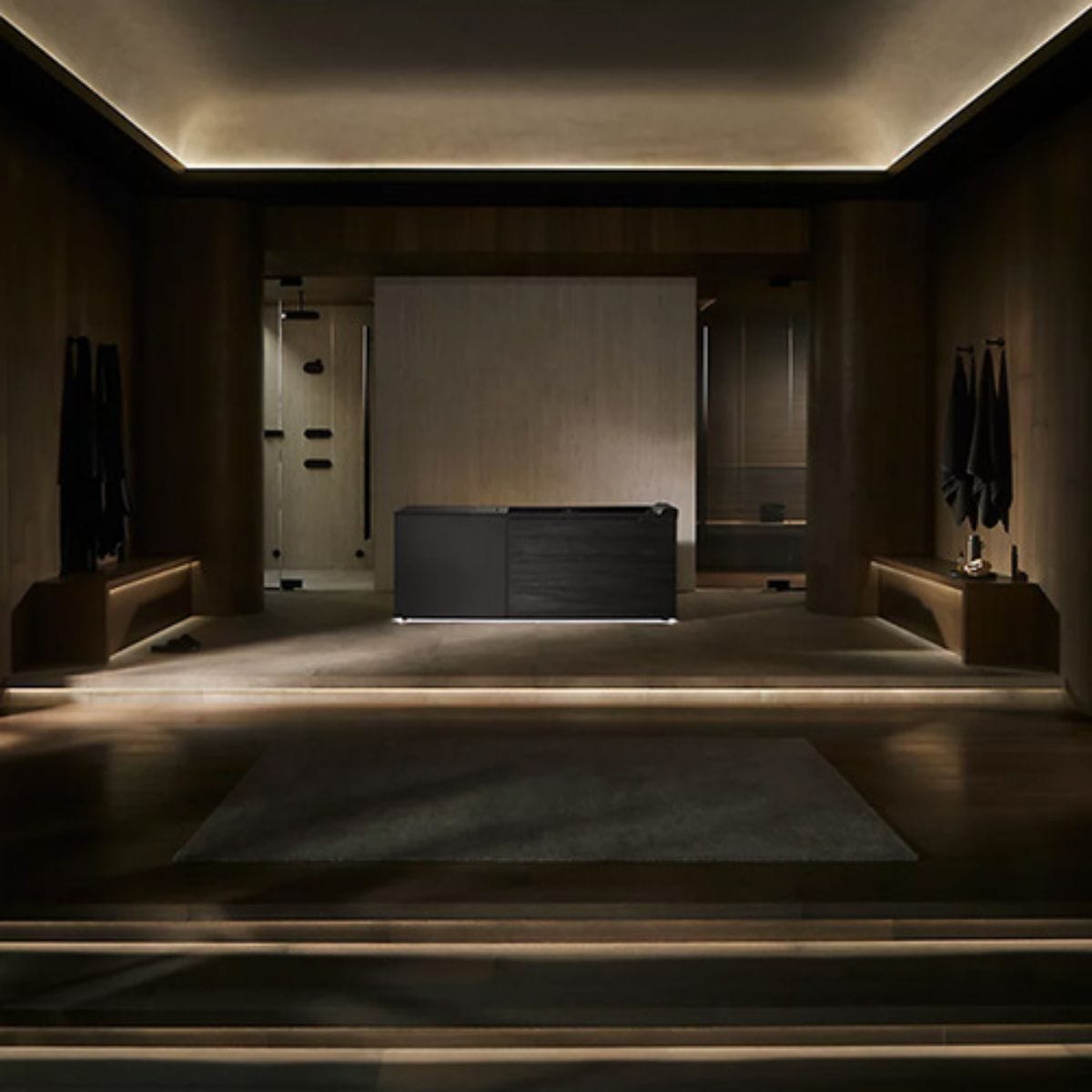Modern bathroom with a large black bathtub in a dimly lit setting