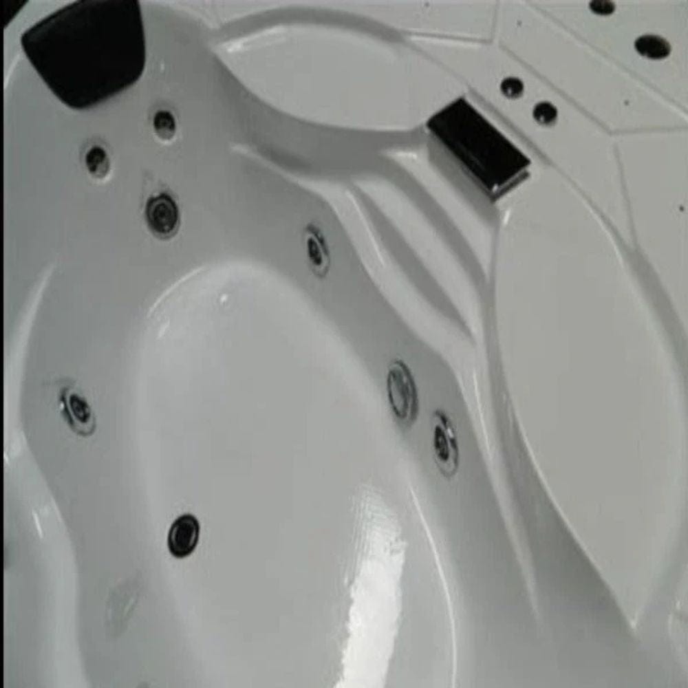 Close-up of a white Jacuzzi bathtub with water jets and control panel.