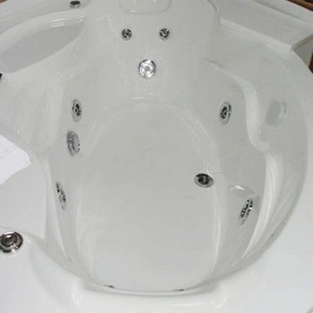 Close-up of a white hot tub with multiple jets.