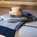 Wooden brush and mitten on a wooden surface