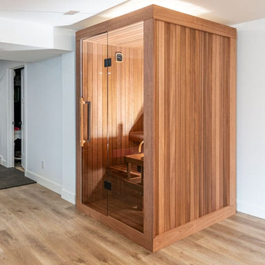 Dundalk CT Element Nook indoor sauna in a hallway corner, glass door closed